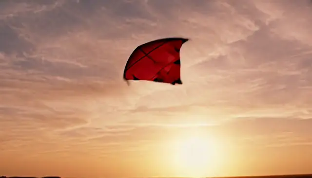 MiniMax H3 2K result for the prompt: a red kite rising over a windswept dune at golden hour, camera tilting up
