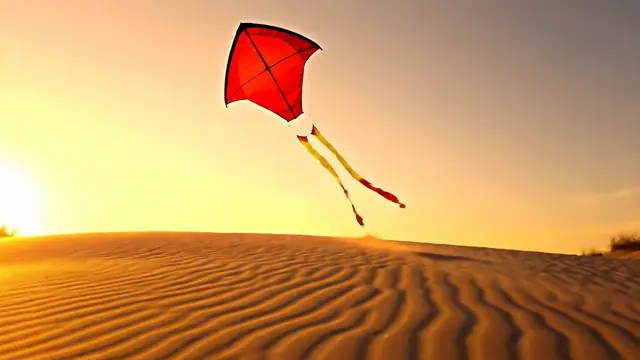 Veo 3.1 result for the prompt a red kite rising over a windswept dune at golden hour, camera tilting up: a red paper kite with tails over rippled sand